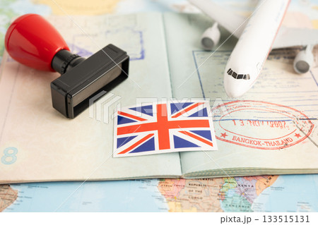 Approved Stamp passport with United Kingdom flag document to immigration at airport in country. Approved Stamp passport with United Kingdom flag document to immigration at airport in country. 133515131