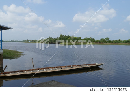 Wooden boat on the river in the nature of thailand and blue sky, view from the pier to the river in summer 133515978