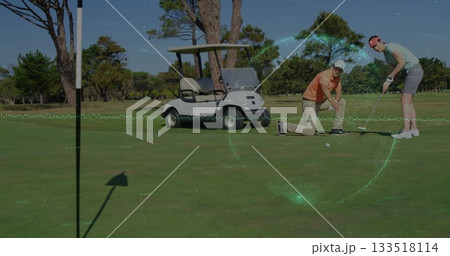 Aligning golf ball, man, woman holding putter on green with glove, golf cart under flagstick shadow 133518114