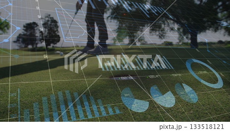 Golfer in polo shirt viewing digital overlays on putting green, with golf ball and putter Golfer in polo shirt viewing digital overlays on putting green, with golf ball and putter 133518121