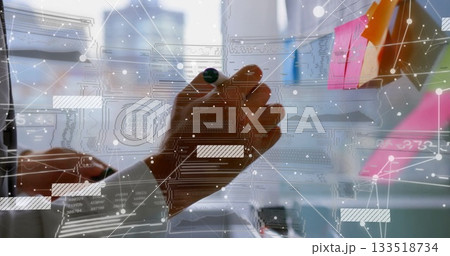 Hand sketching network overlay with marker on glass board in office, colorful sticky notes 133518734