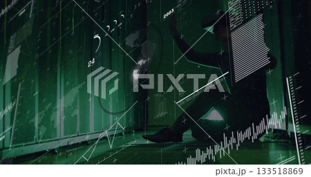 Holding tablet, silhouetted Korean man studying holographic charts in green data center, copy space Holding tablet, silhouetted Korean man studying holographic charts in green data center, copy space 133518869