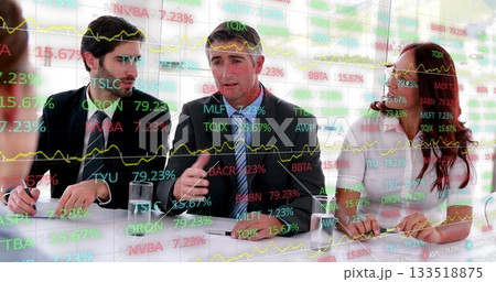 Reviewing data on glass screen, team in suits discussing charts in boardroom, with notebooks, water Reviewing data on glass screen, team in suits discussing charts in boardroom, with notebooks, water 133518875