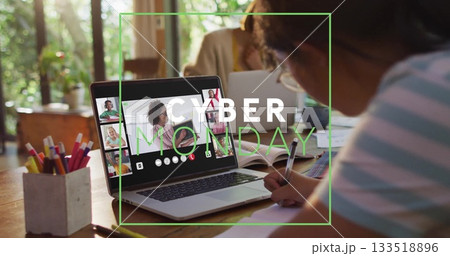 Woman taking notes at home desk for Cyber Monday call, with laptop, pencil holder, copy space 133518896