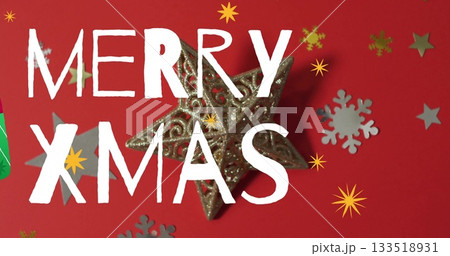 Shining gold star ornament on red table with snowflake star cutouts, hand-drawn white text Shining gold star ornament on red table with snowflake star cutouts, hand-drawn white text 133518931