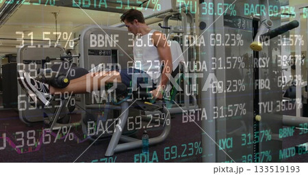 Extending legs on leg extension machine at fitness center wearing sportswear and financial overlays 133519193