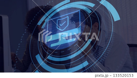 Reviewing cybersecurity overlay specialist and analyst in blazer working at office desk shield icon Reviewing cybersecurity overlay specialist and analyst in blazer working at office desk shield icon 133520153