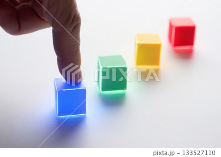 colorful wooden blocks with hand on white background colorful wooden blocks with hand on white background 133527110