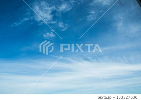Deep blue sky is stretching across frame with wispy cirrus clouds in flat design 133527630