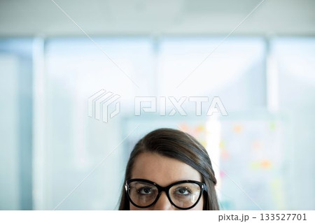 Woman wearing eyeglasses looking up 133527701