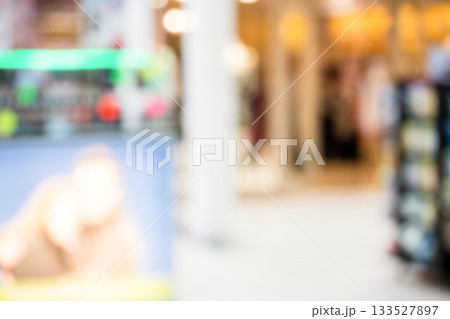 Flat design blurred retail interior is showing bright ad panel and shelves under soft highlights 133527897