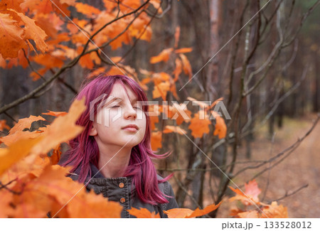 Girl enjoying autumn forest with colorful pink hair 133528012