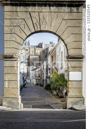 Historic Stone Archway Leading to Quaint Residential Alley 133528545
