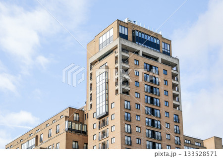 Modern Residential Apartment Building with Balconies and Large Windows 133528571