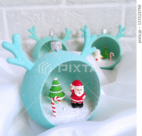 Christmas decorations in the shape of a ball with horns and small figures inside Christmas decorations in the shape of a ball with horns and small figures inside 133528766