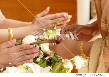 Hands of the groom and bride with wedding bouquet, marriage ceremony Hands of the groom and bride with wedding bouquet, marriage ceremony 133529227