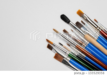 Many different brushes on a white background. Copy space for artistic background. Many different brushes on a white background. Copy space for artistic background. 133529358