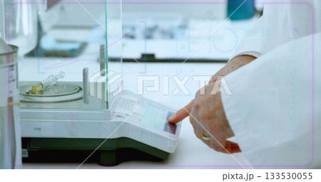 Operating scientist hands in lab coat entering data on analytical scale at lab, syringe, copy space 133530055