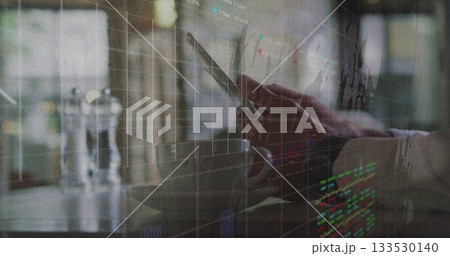 Tapping tablet device by businessman in cafe with coffee cup, glass shakers, showing stock overlay Tapping tablet device by businessman in cafe with coffee cup, glass shakers, showing stock overlay 133530140