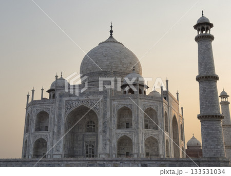 Taj Mahal stands in Agra. White marble mausoleum with domes and minarets shows historic Mughal Taj Mahal stands in Agra. White marble mausoleum with domes and minarets shows historic Mughal 133531034