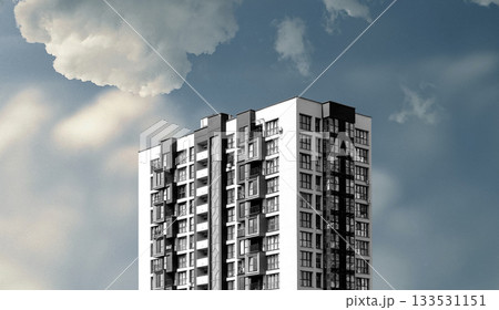Modern residential high-rise building under a dramatic sky with clouds. The white and dark facade 133531151