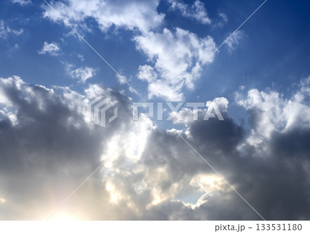 Clouds in blue sky with sunlight. Bright atmosphere with beams and rays, fluffy formations and Clouds in blue sky with sunlight. Bright atmosphere with beams and rays, fluffy formations and 133531180