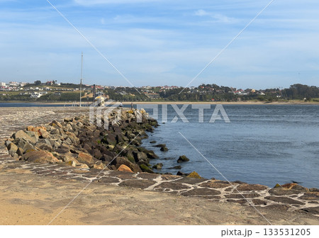 Foz do Douro in Porto Portugal with stone jetty and rocky shoreline at river mouth. Scenic landscape Foz do Douro in Porto Portugal with stone jetty and rocky shoreline at river mouth. Scenic landscape 133531205