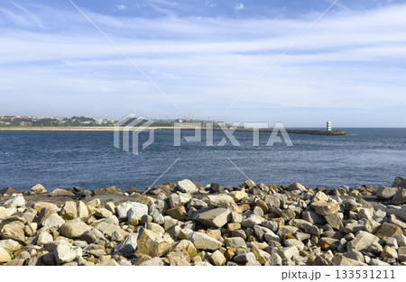 Foz do Douro coast in Porto Portugal with lighthouse and breakwater on Atlantic horizon. Scenic 133531211