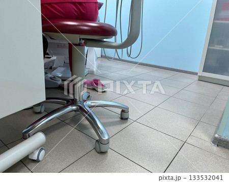 Clinical setting with a doctor's chair and tiled floor seen from below Clinical setting with a doctor's chair and tiled floor seen from below 133532041
