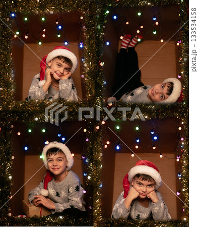 A boy in a knitted sweater and Santa hat sitting in a cardboard box decorated with holiday lights, Christmas collage of four photos. 133534158