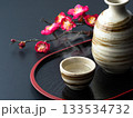 湯気の立つ日本酒と梅の枝の和風イメージ 133534732