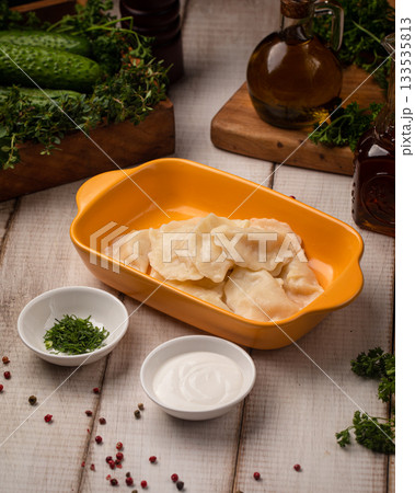 Boiled vareniki dumplings with sour cream Boiled vareniki dumplings with sour cream 133535813
