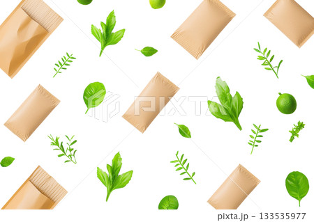 A collection of brown paper packages interspersed with various fresh green herbs and leaves. 133535977