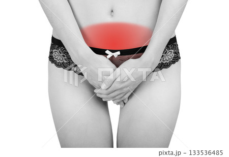 Woman's hands cover her stomach in pain 133536485