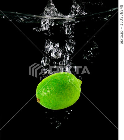 Citrus Lime falling into the water 133536548