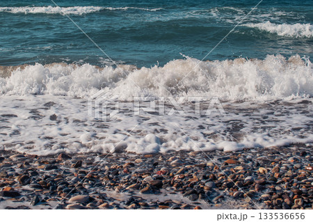 Waves crashing against the seashore with dramatic splashes 133536656