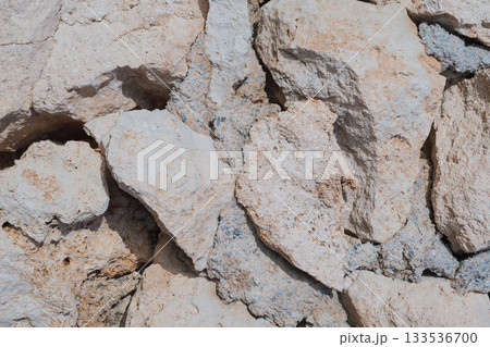 Old natural stone masonry without mortar between the stones, natural background 133536700