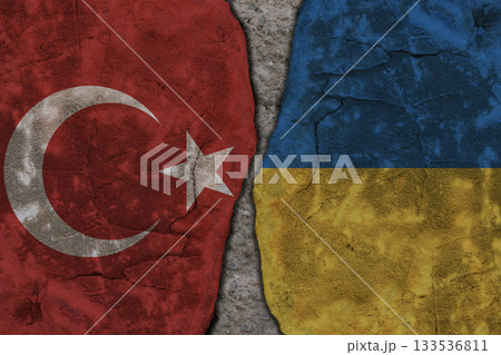 Symbolic split between Turkey and Ukraine flags on cracked stone wall texture 133536811