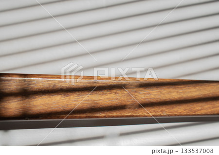 Wooden steps bathed in sunlight through blinds Wooden steps bathed in sunlight through blinds 133537008