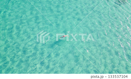 Young man swimming with mask in crystal clear turquoise sea water. Young man swimming with mask in crystal clear turquoise sea water. 133537104