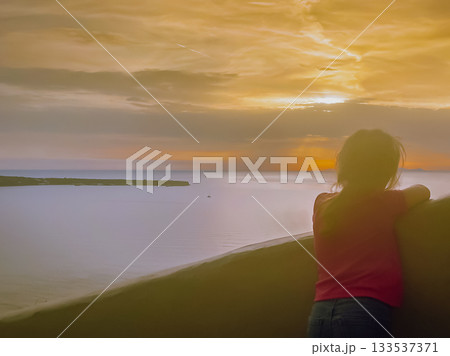 Silhouetted child against the colorful golden hour sky in picturesque cliffside village of Santorini Silhouetted child against the colorful golden hour sky in picturesque cliffside village of Santorini 133537371
