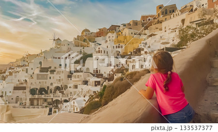 Child standing in a picturesque setting with famous whitewashed walls blue dome of island Santorini Child standing in a picturesque setting with famous whitewashed walls blue dome of island Santorini 133537377