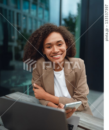 casual shot outdoors with device, authentic social media image amidst modern architecture and daylight casual shot outdoors with device, authentic social media image amidst modern architecture and daylight 133537397