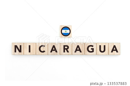 Wooden blocks bearing the name and flag of Nicaragua. Nicaraguan and Caribbean Culture, national identity, travel, and geography in a copy space design. 133537883