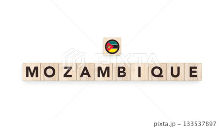 Wooden blocks bearing the name and flag of Mozambique. Mozambican and South African Culture, national identity, travel, and geography in a copy space design. 133537897
