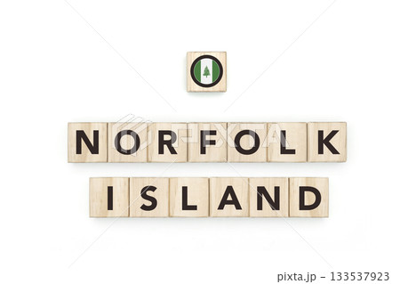 Wooden blocks bearing the name and flag of Norfolk Island. Australian Culture, national identity, travel, and geography in a copy space design. Wooden blocks bearing the name and flag of Norfolk Island. Australian Culture, national identity, travel, and geography in a copy space design. 133537923