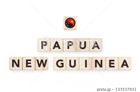 Wooden blocks bearing the name and flag of Papua New Guinea. Austral and Polynesian Culture, national identity, travel, and geography in a copy space design. 133537931