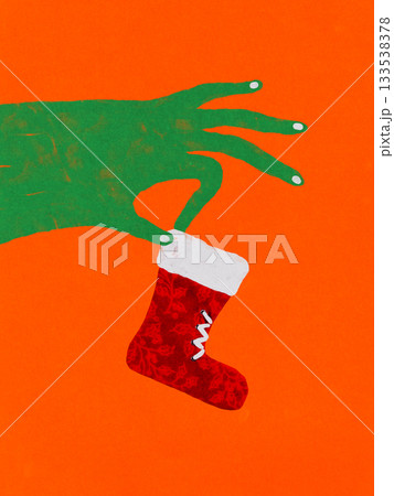 Vivid collage. Hand holding small red Christmas stocking with playful emotion Vivid collage. Hand holding small red Christmas stocking with playful emotion 133538378