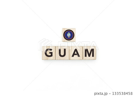 Wooden blocks bearing the name and flag of Guam. Guamanian and Micronesian Culture, national identity, travel, and geography in a copy space design. Wooden blocks bearing the name and flag of Guam. Guamanian and Micronesian Culture, national identity, travel, and geography in a copy space design. 133538458