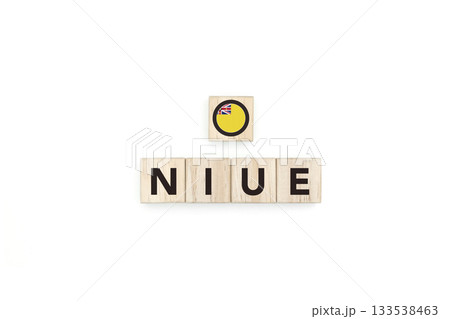 Wooden blocks bearing the name and flag of Niue. Niuean and Micronesian Culture, national identity, travel, and geography in a copy space design. Wooden blocks bearing the name and flag of Niue. Niuean and Micronesian Culture, national identity, travel, and geography in a copy space design. 133538463